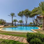 Penthouse in Santa Ponsa - Einladender Gemeinschaftspool mit Palmen und Blick aufs Meer